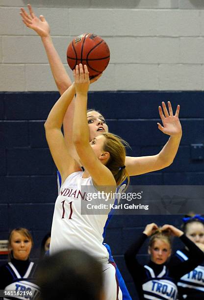 Longmont center Megan Carpenter goes up to swat away a shot by Cheyenne Mountain guard Vivian Snider in the first half Saturday night. The Longmont...