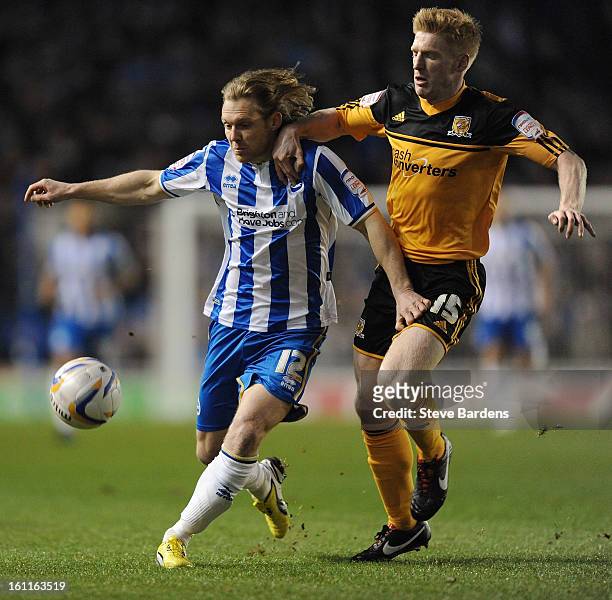 Craig Mackail-Smith of Brighton & Hove Albion challenges for the ball with Paul McShane of Hull City during the npower Championship match between...