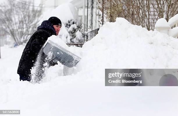 Resident David Haughton shovels the sidewalk outside his home after Winter Storm Nemo in Somerville, Massachusetts, U.S., on Saturday, Feb. 9, 2013....