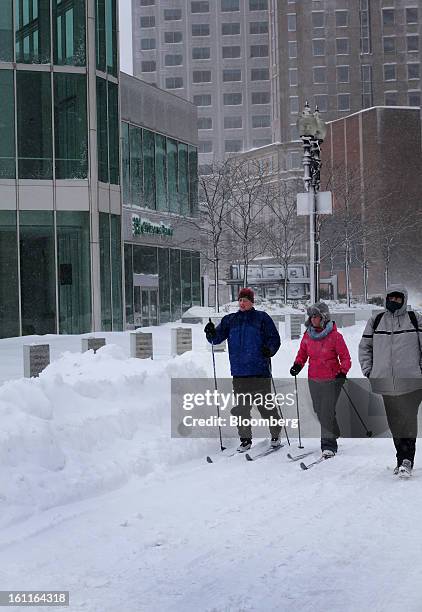 Pedestrians ski down Summer Street after Winter Storm Nemo in Boston, Massachusetts, U.S., on Saturday, Feb. 9, 2013. More than two feet of snow fell...