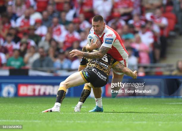 Shaun Kenny-Dowall of Hull Kingston Rovers is challenged by Ben Reynolds of Leigh Leopards during Betfred Men's Challenge Cup Final match between...