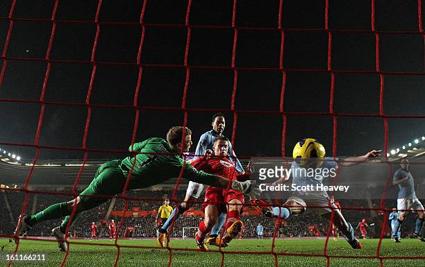 Joe Hart of Manchester City dives in vain as Steven Davis of Southampton scores their second goal during the Barclays Premier League match between...