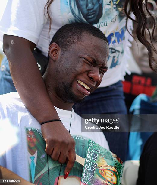 Stephen Martin a cousin of Trayvon Martin is overcome with emotion during the "March for Peace" at Ives Estate Park in honor of the late Trayvon...