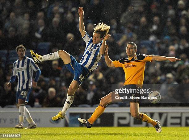 Craig Mackail-Smith of Brighton & Hove Albion challenges for the ball with Jack Hobbs of Hull City during the npower Championship match between...