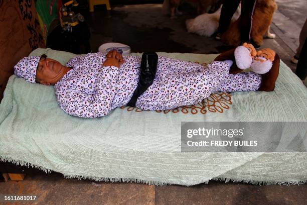 Man simulates to be asleep during the celebration of World Day of Laziness in Itagui, Colombia, on August 20, 2023.