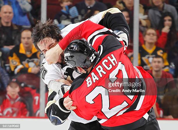 Deryk Engelland of the Pittsburgh Penguins and Krystofer Barch of the New Jersey Devils fight during a game at the Prudential Center on February 9,...