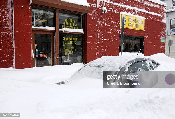 Car sits buried in snow on Highland Avenue after Winter Storm Nemo in Somerville, Massachusetts, U.S., on Saturday, Feb. 9, 2013. More than two feet...