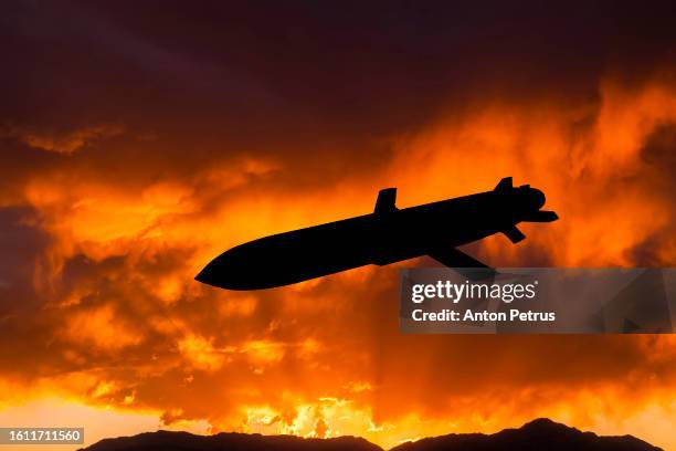 stealth missile against the sunset sky - cruise missile stock pictures, royalty-free photos & images