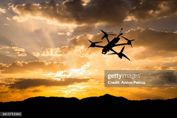 fpv-drone against the sunset sky - multicopter stock pictures, royalty-free photos & images