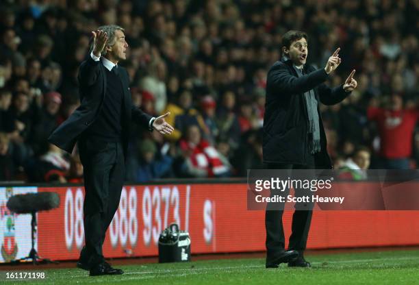 Manager Mauricio Pochettino of Southampton and manager Roberto Mancini of Manchester City give instructions during the Barclays Premier League match...