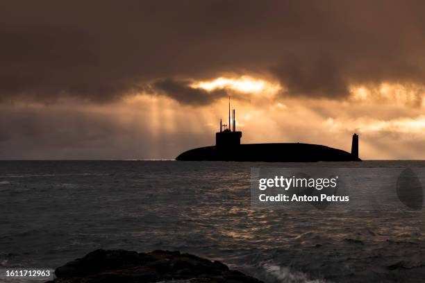 nuclear submarine at sea at sunset - military convoy stock pictures, royalty-free photos & images