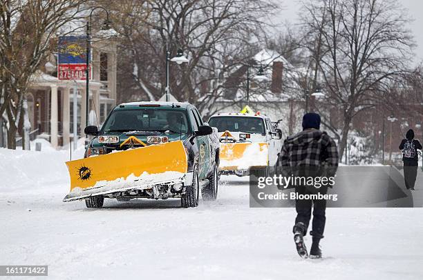 Snow plows drive down Harvard Street after Winter Storm Nemo in Brookline, Massachusetts, U.S., on Saturday, Feb. 9, 2013. More than two feet of snow...