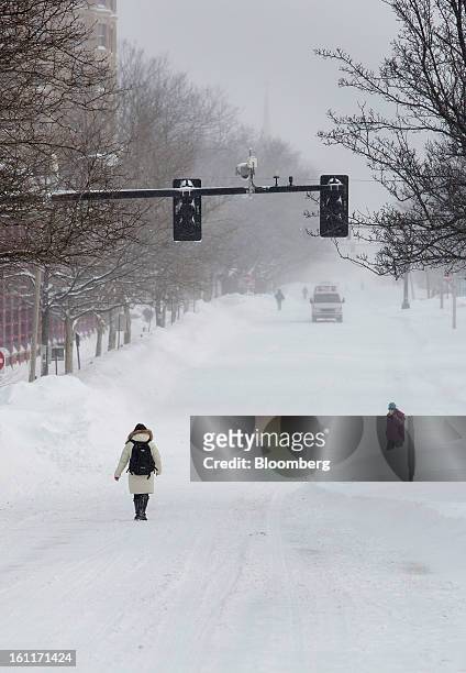 Pedestrians walk in the snow down Beacon Street after Winter Storm Nemo in Brookline, Massachusetts, U.S., on Saturday, Feb. 9, 2013. More than two...
