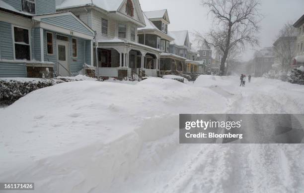 Cars sit buried under snow after Winter Storm Nemo in Boston, Massachusetts, U.S., on Saturday, Feb. 9, 2013. More than two feet of snow fell on...