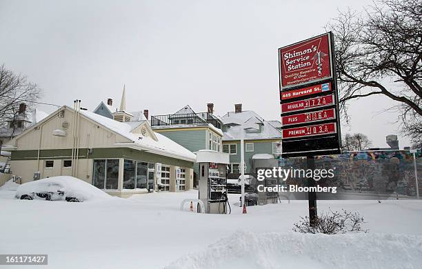 Gas pumps sit buried under snow at Shimon's Service Station on Harvard Street after Winter Storm Nemo in Brookline, Massachusetts, U.S., on Saturday,...