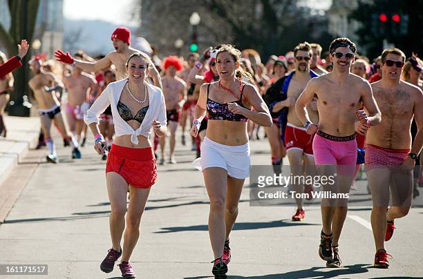 Runners race along 1st Street, during Cupid's Undie Run on Capitol Hill. The 1 1/2 mile event raises money for The Children's Tumor Foundation.