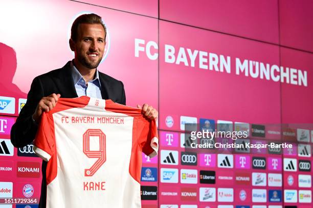 Harry Kane of FC Bayern München poses for a photograph whilst holding a FC Bayern München shirt, which reads "9 Kane", after speaking to the media...