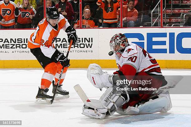 Cam Ward of the Carolina Hurricanes makes a save on Matt Read of the Philadelphia Flyers late in the third period on February 9, 2013 at the Wells...