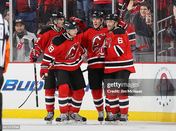Bobby Butler of the New Jersey Devils celebrates his third period goal against the Pittsburgh Penguins with teammates Adam Henrique, Steve Bernier...