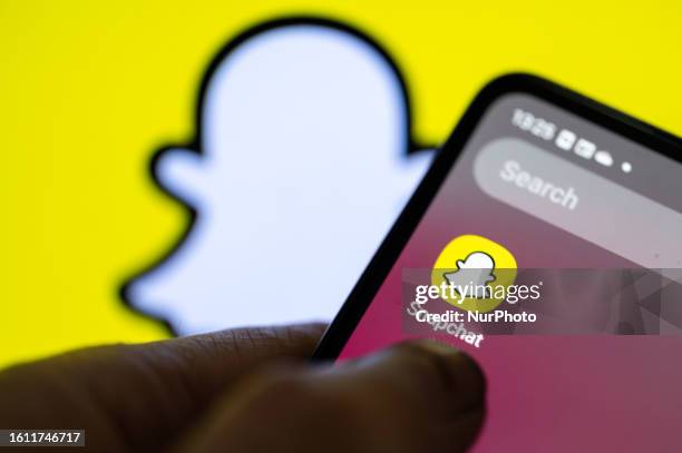 SnapChat icon displayed on a smart phone with in the background SnapChat logo, seen in this photo illustration, on August 20 in Brussels, Belgium.