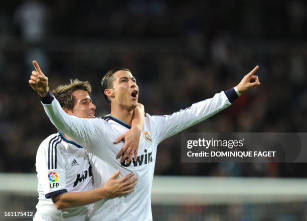 Real Madrid's Portuguese forward Cristiano Ronaldo celebrates his goal with Real Madrid's Portuguese defender Fabio Coentrao during the Spanish...