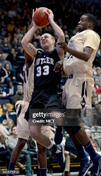 Butler guard Chase Stigall takes the ball up for a score against George Washington guard Lasan Kromah , back, and George Washington forward Isaiah...