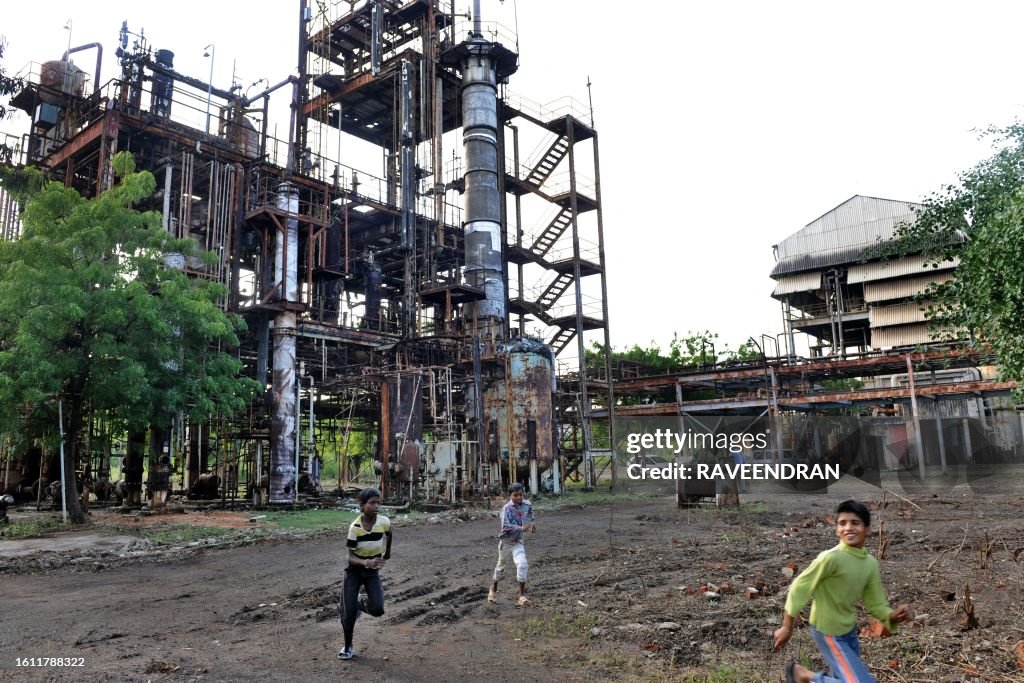 Ucil Factory Children play in front of the Union Carbide factory in Bhopal on ...