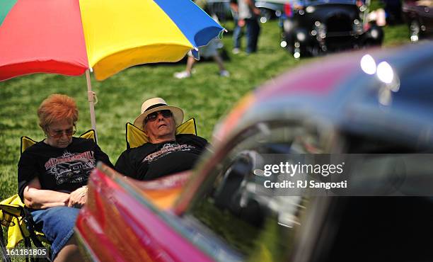 Billie Zumo, left, his her husband Charlie Zumo, of Cheyenne Wyoming, nap behind their 1955 Ford Crown Victoria Skyliner, Friday, June 03 during the...