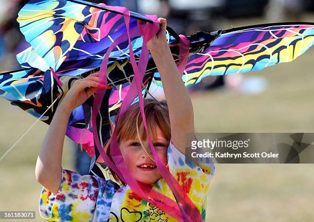 Brooke Payne from Arvada holds her kite above her head hoping for the next upcoming breeze. The Arvada Festivals Commission and the Foothills Kite...