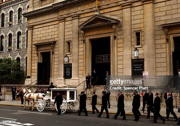 Horse-drawn carriage carries R&B singer Aaliyah''s coffin towards the St. Ignatius Loyola Church for services August 31, 2001 in New York City. The...