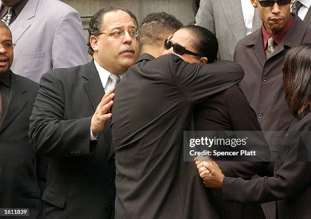 Diane Haughton , mother of the late R&B star Aaliyah, is embraced after funeral services for her daughter August 31, 2001 at St. Ignatius Loyola...