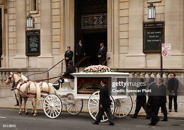 Horse-drawn carriage carries R&B singer Aaliyah''s coffin towards the St. Ignatius Loyola Church for services August 31, 2001 in New York City. The...