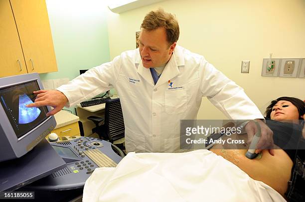 Dr. Stephen Scott, MD., left, performs an ultrasound on Daniela Hernandez, 16-years-old, 19-weeks pregnant, at Children's Hospital Thursday...