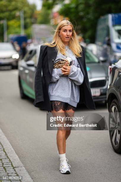 Guest wears a pale gray sweater, a black blazer jacket, a black lace cut-out pattern short skirt, a beige and black polka dots print pattern fur...