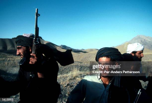 Unidentified Taliban soldiers patrol July 25, 1996 outside Kabul, Afghanistan. The Taliban have taken over most of the country in 1996 and have...