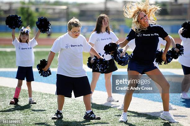 Dylan Secrist, 13-years-old, with Down Syndrome, second from left, works a cheer routine from Denver Broncos cheerleader, Jenna Jaeger, right, along...