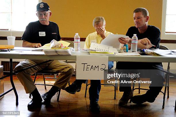 Volunteers John Baker, Mike Cowan and Ron Briggs count ballots during a hand review of voted ballots for the clerk and commissioner races of Saguache...