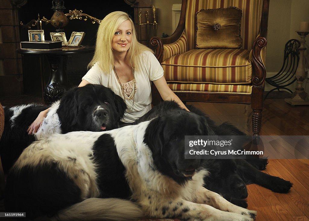 Heather Smith-Hillman at her Denver home with three Newfoundlands, Olaf, 5, left, Gladys, 2, foreground, and Opal,4, solid black right on Wednesday, August 31, 2011. Smith-Hillman has created an natural salon quality grooming products for dogs called Pure