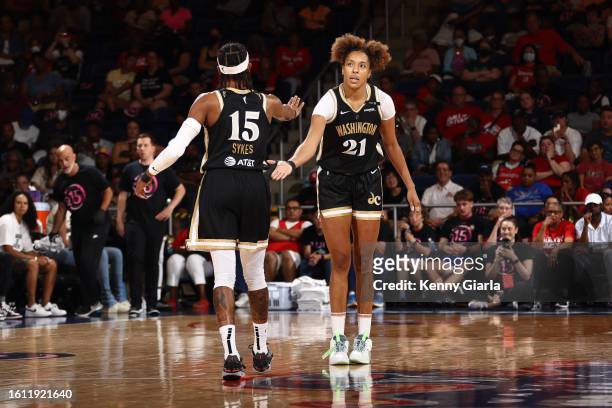 Brittney Sykes and Tianna Hawkins of the Washington Mystics celebrate during the game against the Dallas Wings on August 20, 2023 at Entertainment &...