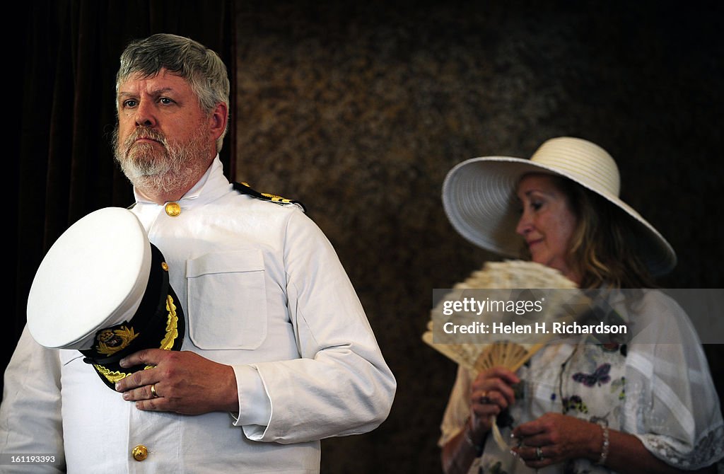 John Steinle, left, portrays Captain Edward John Smith, captain of the Titanic and Mary Van Meter, a docent at the museum who is dressed in period costumes, reenacted the day of the sinking of the Titanic to a roomful of visitors. The Molly Brown House Mu
