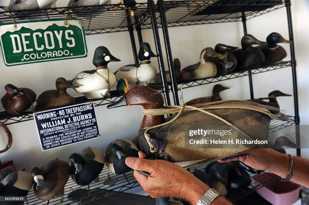 William Walters shows off some of the many dozens of decoy ducks that he uses during duck hunting season on July 16th, 2012. This decoy of a Canvasback duck has the original rope and anchor that came attached to it circa 1930's-40's. William Walters is a 