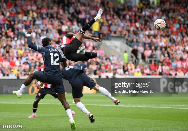 Rico Henry of Brentford battles for possession with Emerson Royal and Oliver Skipp of Tottenham Hotspur during the Premier League match between...
