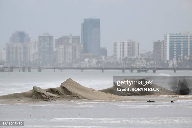 Diminished sand berms are seen on the beach in Long Beach, California, on August 20, 2023. Hurricane Hilary weakened to a tropical storm on August 20...