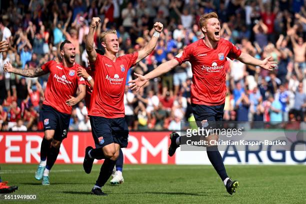 Mathias Fetsch of SpVgg Unterhaching celebrates with teammates after scoring the team's first goal during the DFB cup first round match between SpVgg...