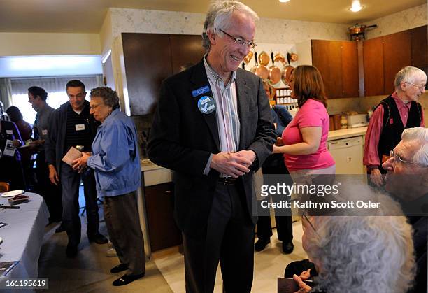 Mayoral candidate Doug Linkhart visits with potential voters at the Denver home of Sam and Aroxie Feldman on Saturday, Jan. 29, 2011. Kathryn Scott...