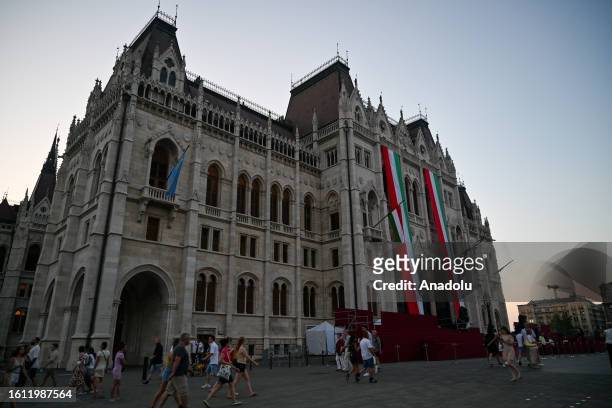 Citizens and tourists gather around Hungarian Parliament Building on the evening hours to mark Hungary's National Day celebrations in Budapest,...
