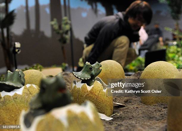 Programer and robotics engineer for KumoTek, Masahiro Ishida, programs the interactive behavior for the Triceratops and her nest of babies just...