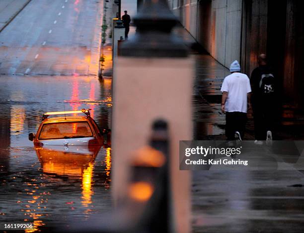 Car was abandoned for the night in standing water beneath the railroad tracks where Broadway turns into Brighton Boulevard north of downtown Denver....