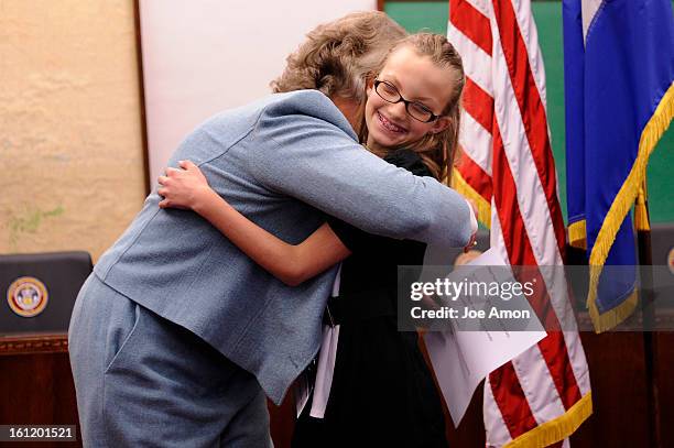 Sen. Jeanne Nicholson hugs 11 year old Sarah Burke from Dillon Valley Elementary in Silverthorne after swearing her in as a youth senator during the...