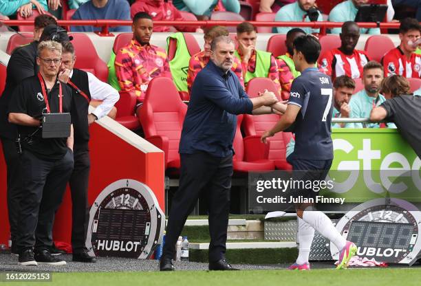 Heung-Min Son of Tottenham Hotspur interacts with manager Ange Postecoglou following his substitution during the Premier League match between...